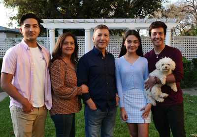 Vicente Sarmiento with has family and family dog